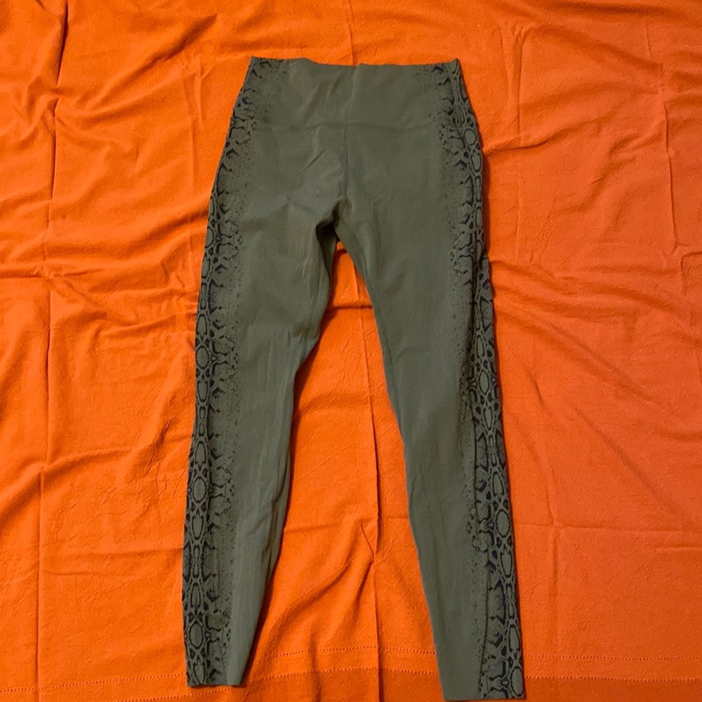 Green leggings with snake print down the side